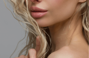 Close up of womans Lips with Fashion pink Make up and Manicure on Nails