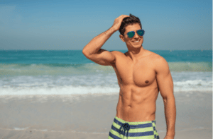 Handsome smiling man enjoying day on the beach.